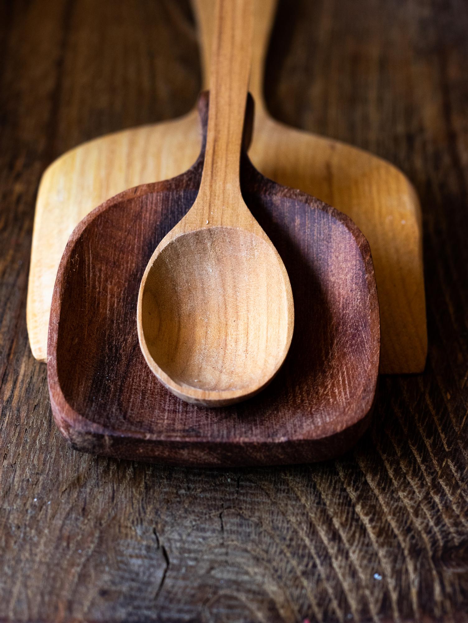 Close-up of tasting spoons on a wooden board