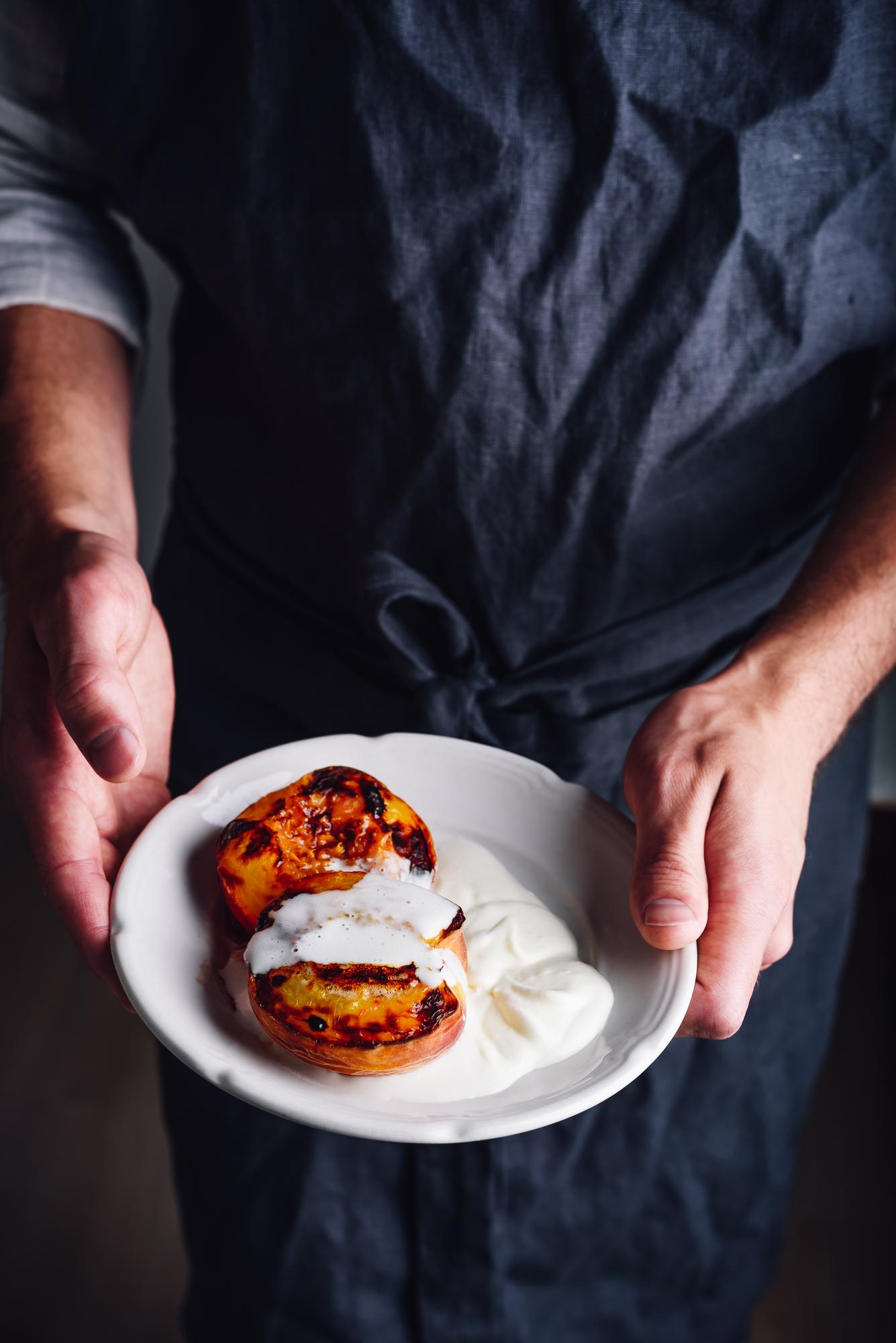 Chef preparing a plated dish with calm focus